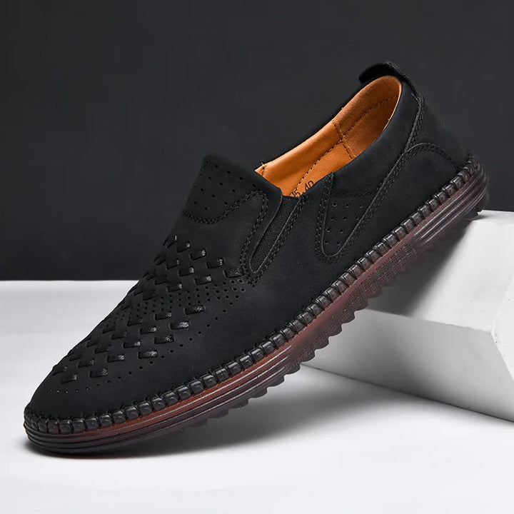 Close-up of a men's classic loafer texture, showing quality stitching and breathable material.