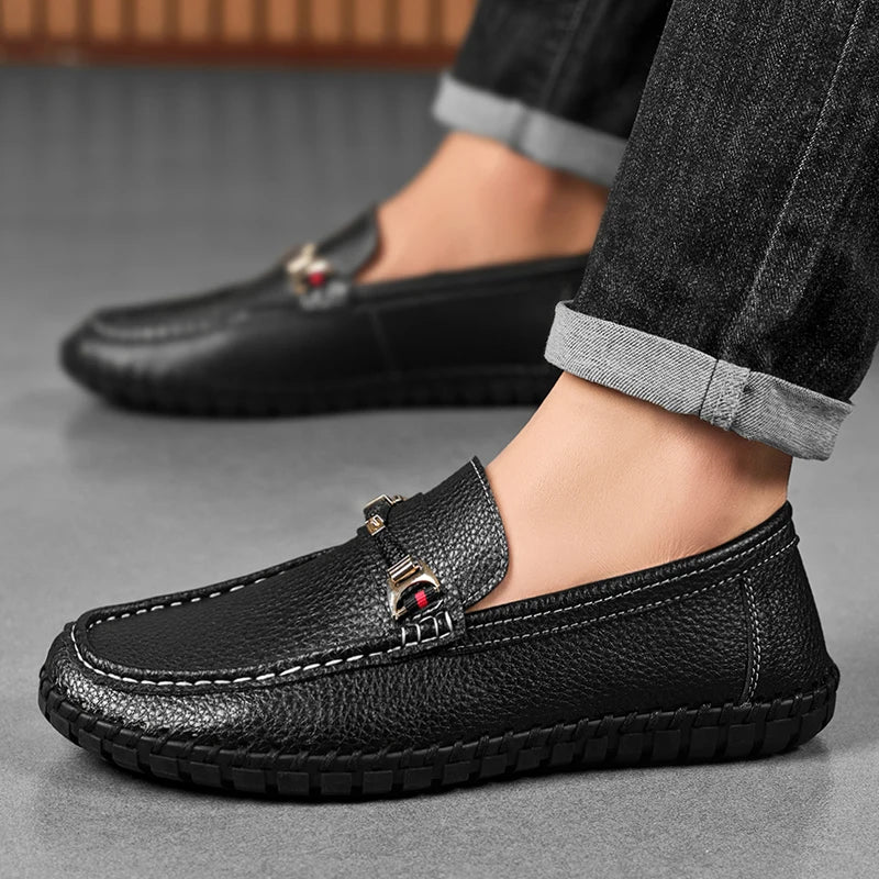 Lifestyle shot of men's classic black leather bit loafers paired with dark trousers, sleek and professional