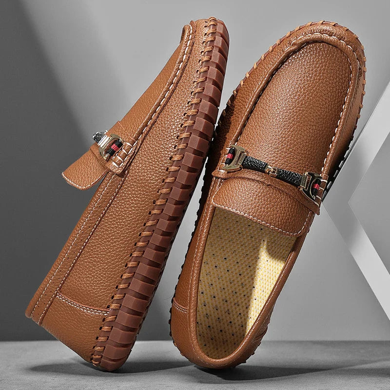 Men's dark brown leather bit loafers on a wooden floor, exuding timeless style and comfort