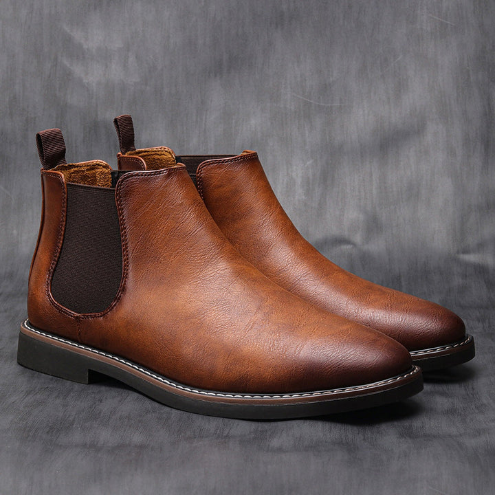 Close-up of men's brown Chelsea boots, showcasing genuine leather and durable sole