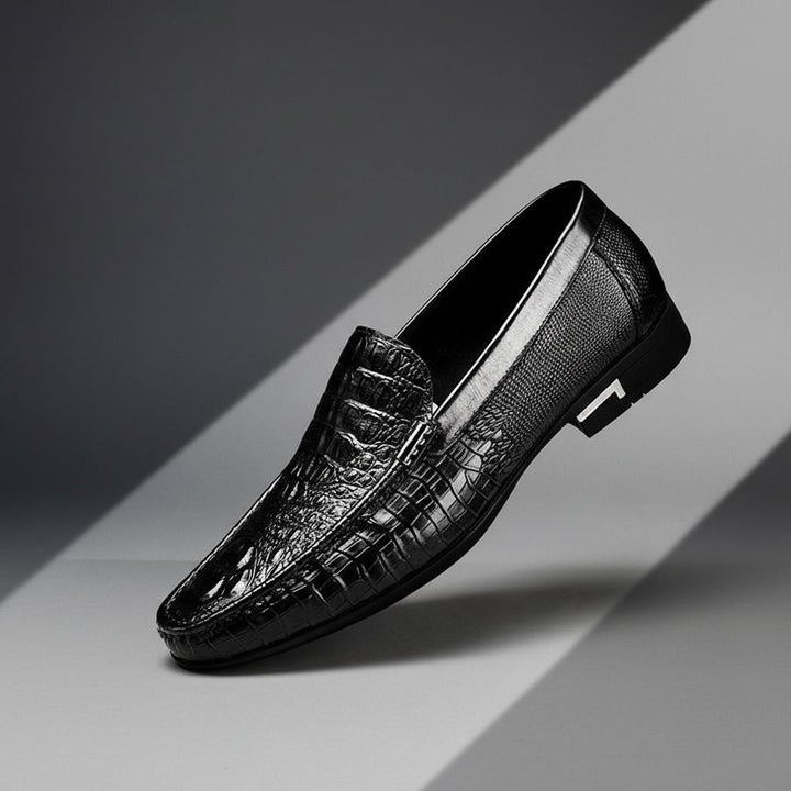 Sleek men's crocodile embossed slip-on loafers. Practical and stylish dress shoes for professional, formal, or casual outfits.