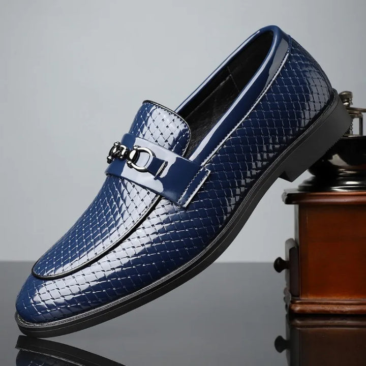 Stylish men's embossed leather bit loafers with a subtle gleam, suitable for formal or informal settings.