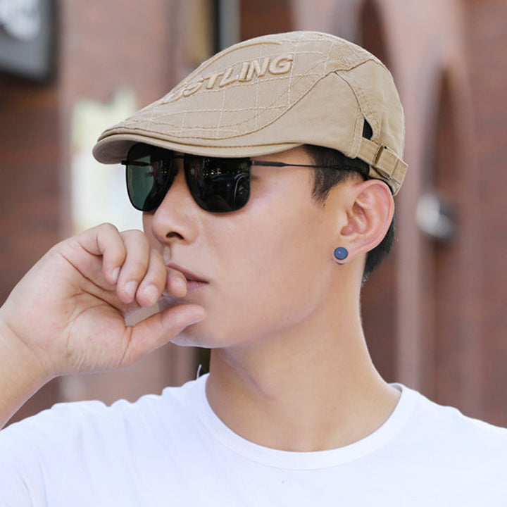 Side view of a men's embroidered cotton beret, highlighting its traditional shape and quality material.