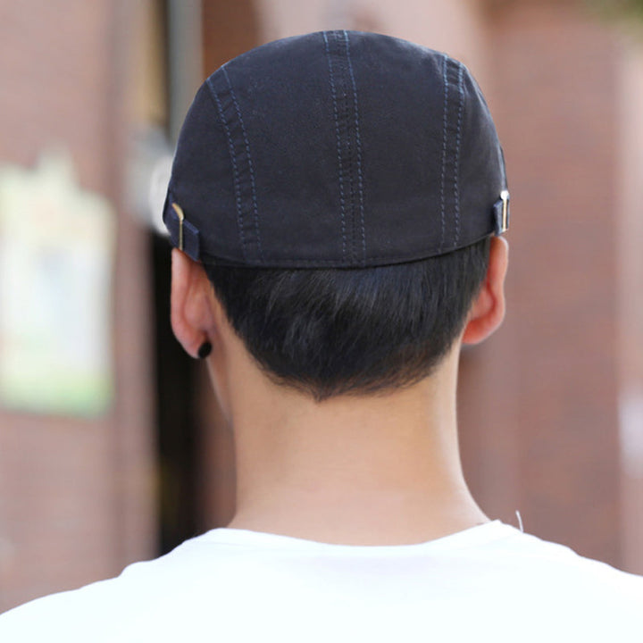Overhead view of a men's embroidered cotton beret, showing its full circular design.