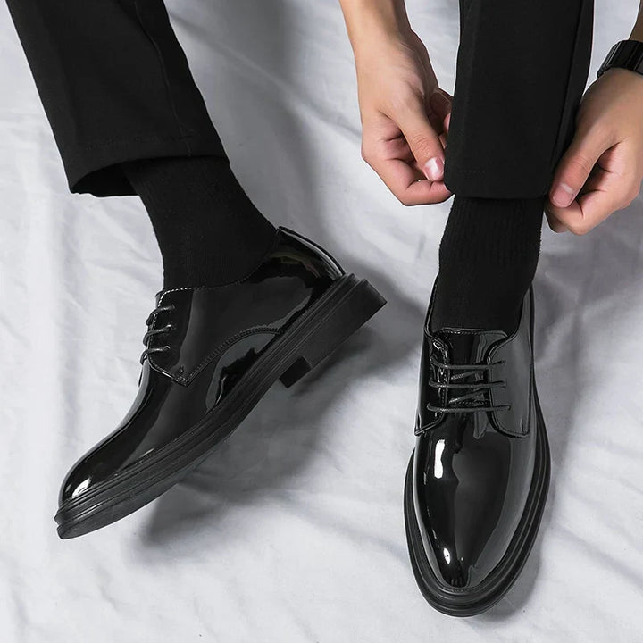 Classic men's black patent leather Derby dress shoes with a glossy finish, essential for formal events & suits.
