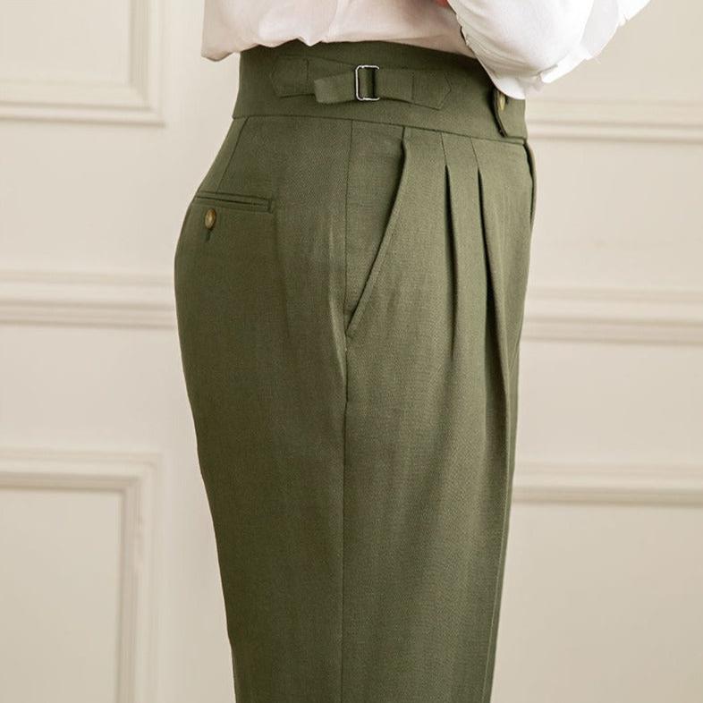 Adjustable waist feature on men's high-waisted pleated dress pants, ensuring a customized formal fit.
