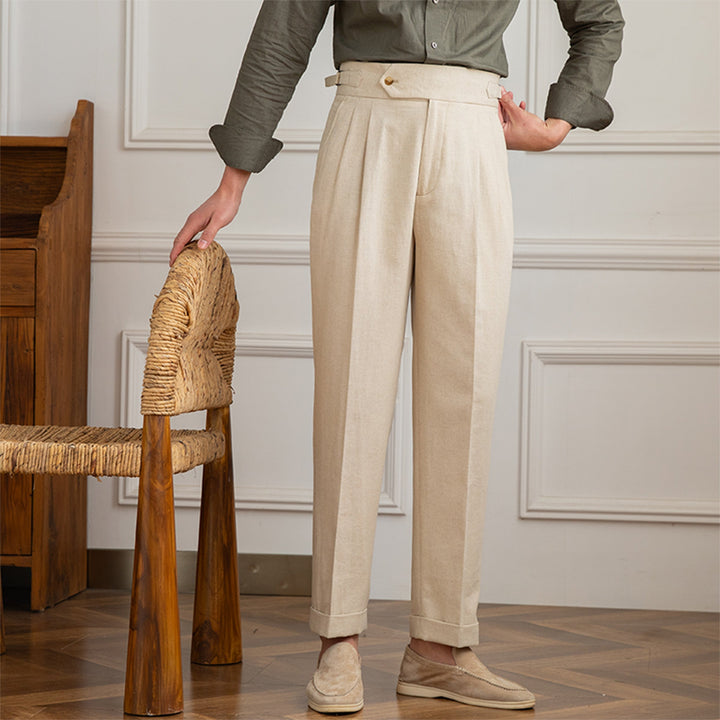 Close-up of elegant men's pleated trousers, showcasing front pleats for a sophisticated formal look.