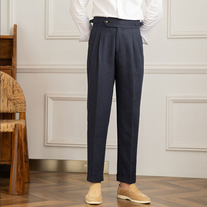 Men's high-waisted pleated trousers styled with a shirt, exuding elegant Italian formal fashion.