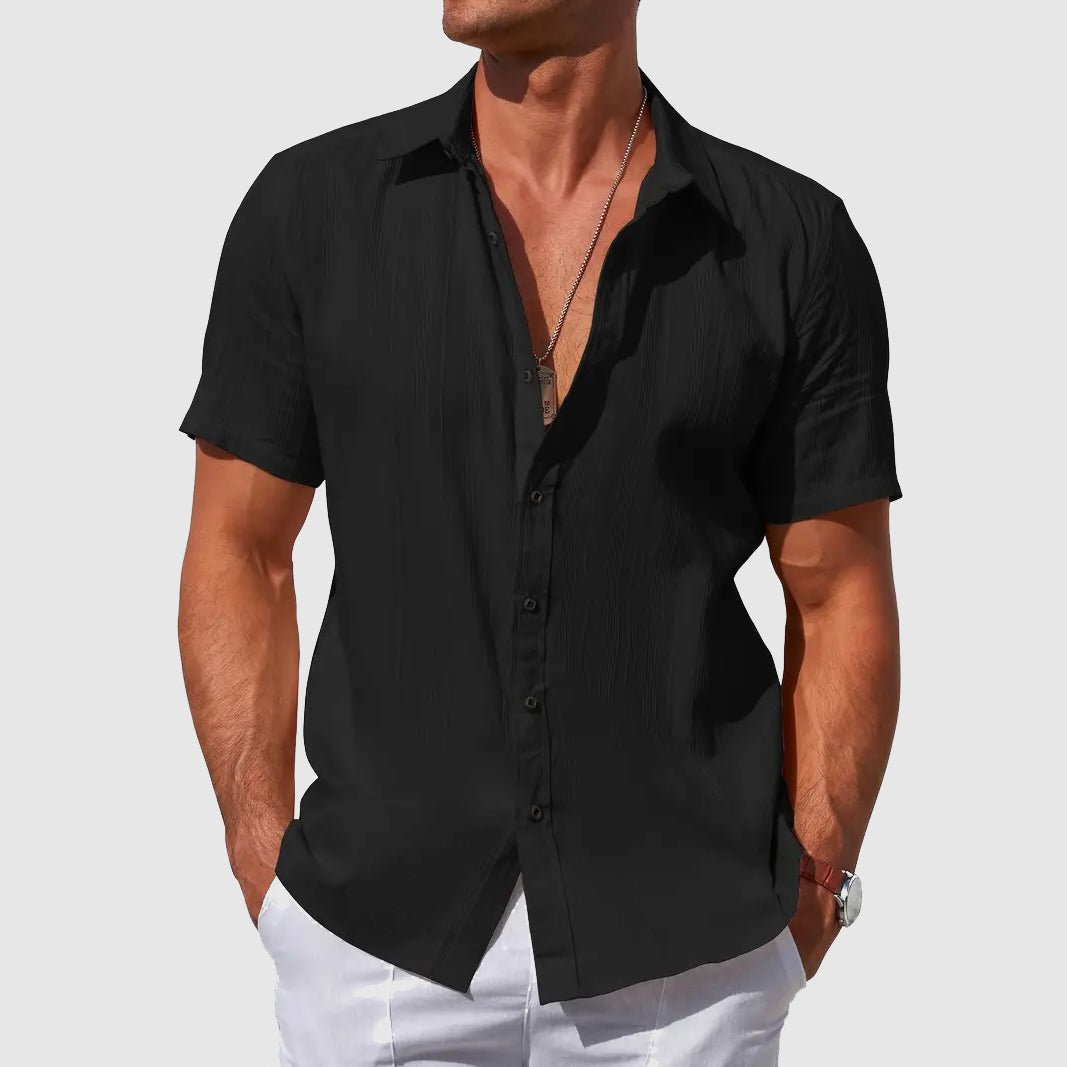 Black men's casual textured short sleeve shirt with button front, ideal for warm weather.