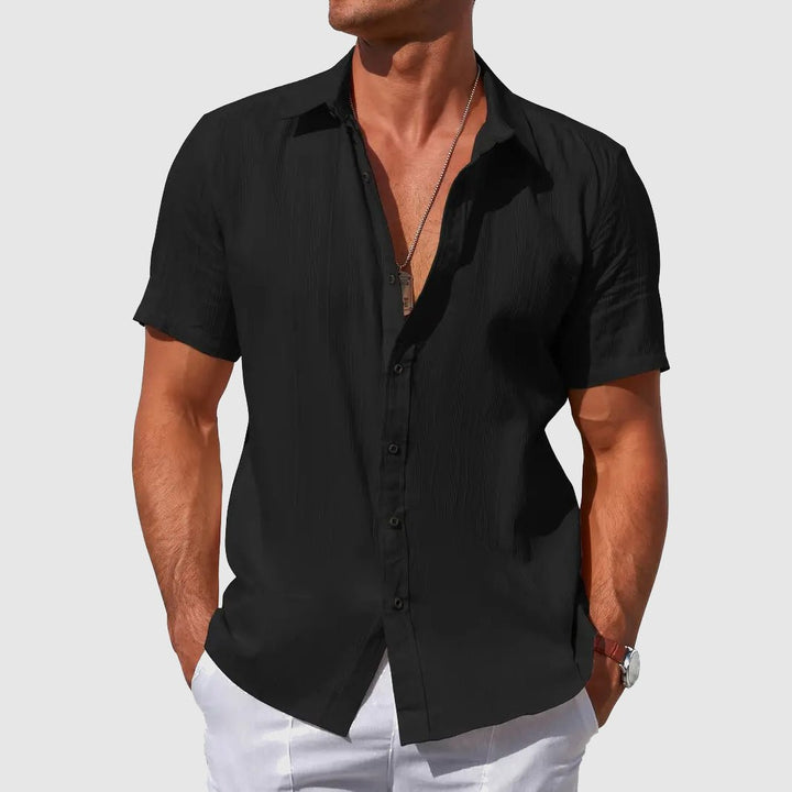 Black men's casual textured short sleeve shirt with button front, ideal for warm weather.