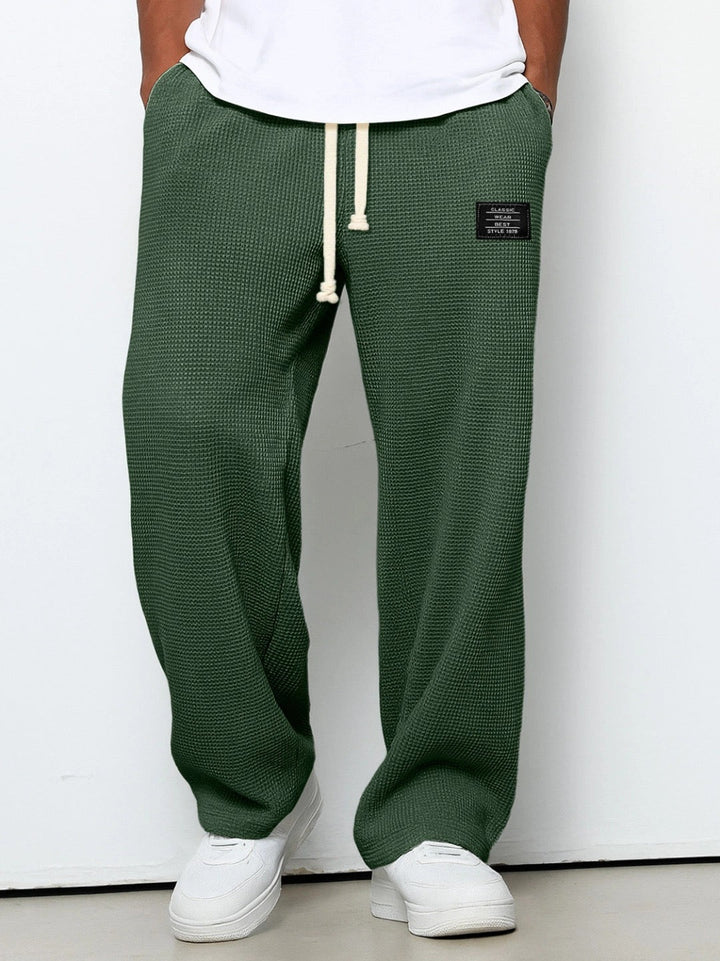 Stylish men's wide leg pants, loose fit, with a practical drawstring for comfort.