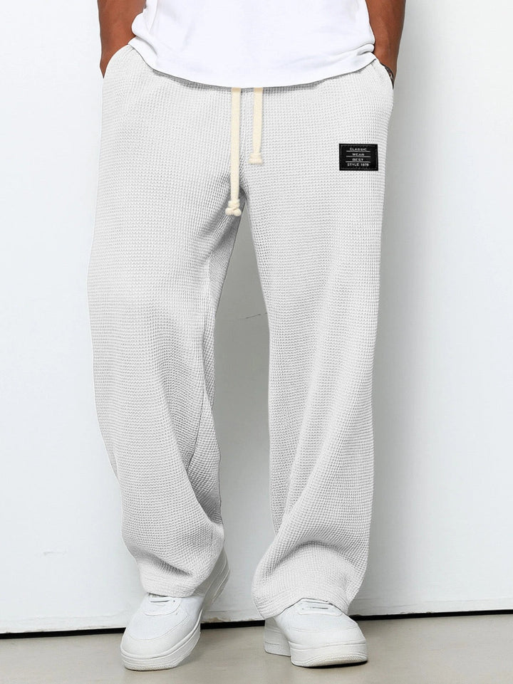 Men's loose fit chino trousers with drawstring for versatile, comfortable style.