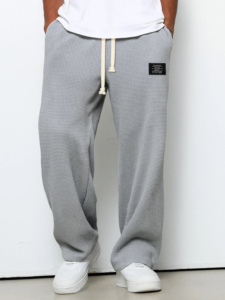 Relaxed fit men's comfort pants with drawstring, perfect for lounging or casual outings.