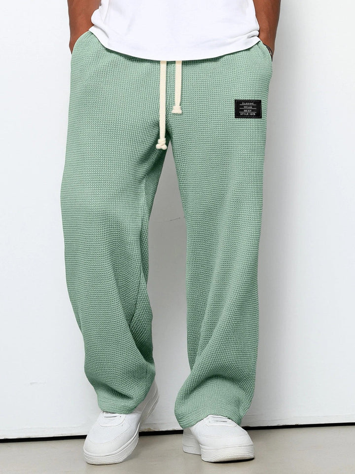 Versatile men's loose fit trousers with drawstring, great for everyday casual wear.