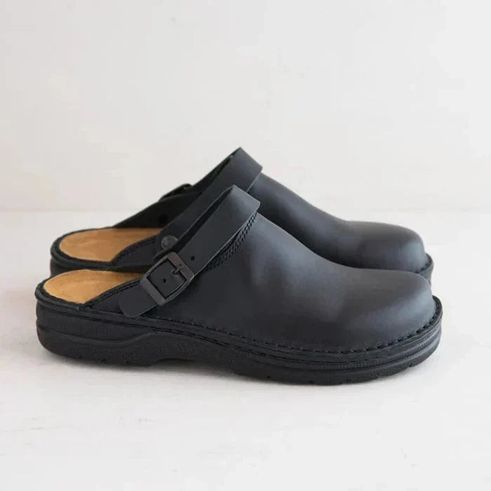 Pair of men's brown slip-on leather clogs, a blend of comfort and timeless elegant style.