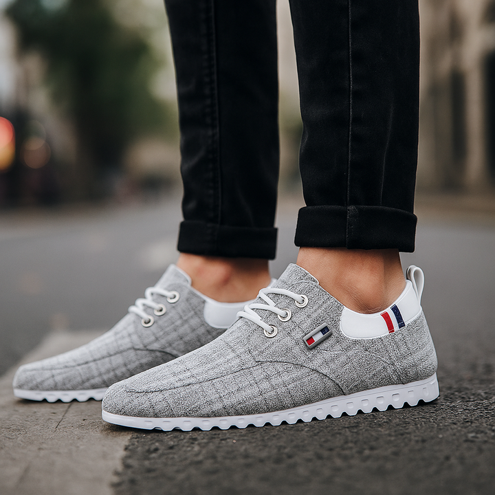 Side profile of Men's Knit Comfort Sneakers, showcasing their modern design and casual appeal.