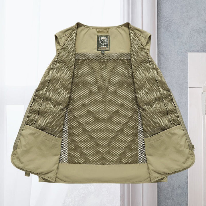Lightweight men's travel vest, multi-pocket design for essentials & comfortable exploration.