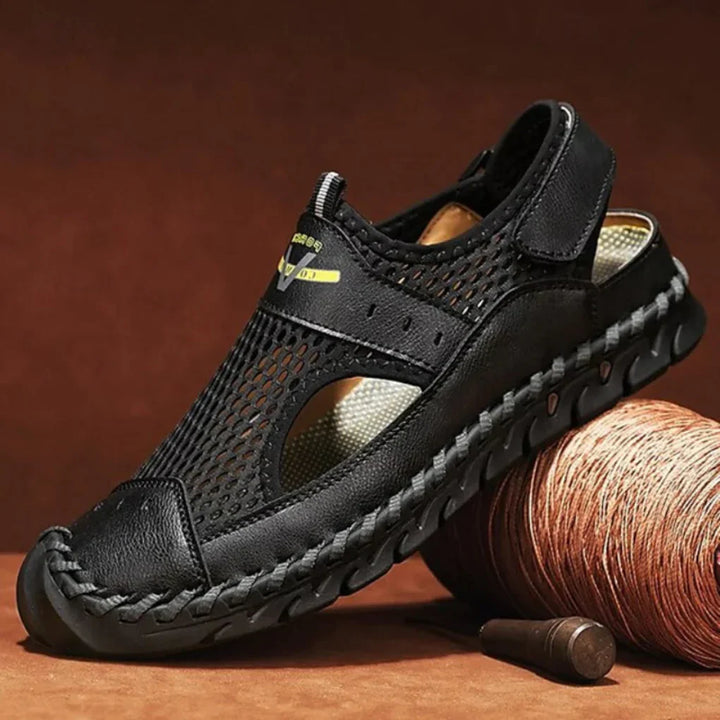 Close-up of men's breathable outdoor sandals in black, showing adjustable straps for comfort