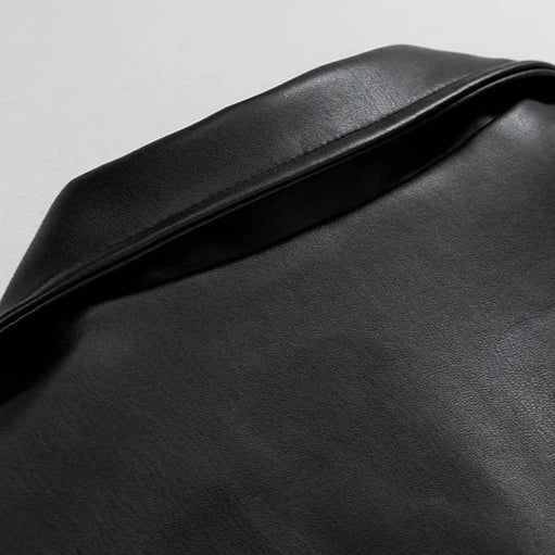 Detail of the ribbed cuffs and hem on a men's oversized black faux leather bomber winter jacket