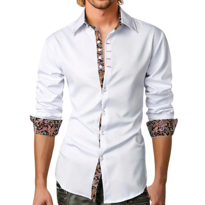 Detail of men's paisley patterned long sleeve shirt fabric and button-down collar. Quality menswear.