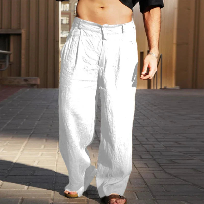 Close-up of men's high-waisted pleated chino pants, showcasing the stylish wide leg and comfortable loose fit.