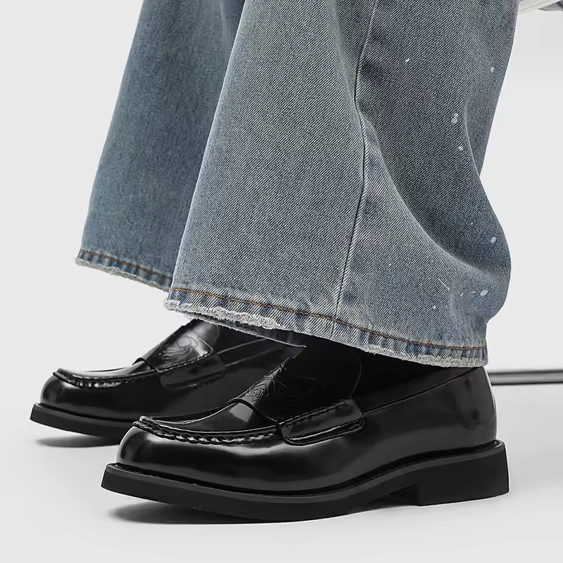 Classic men's polished black leather loafers. Stylish formal footwear for refined business looks.