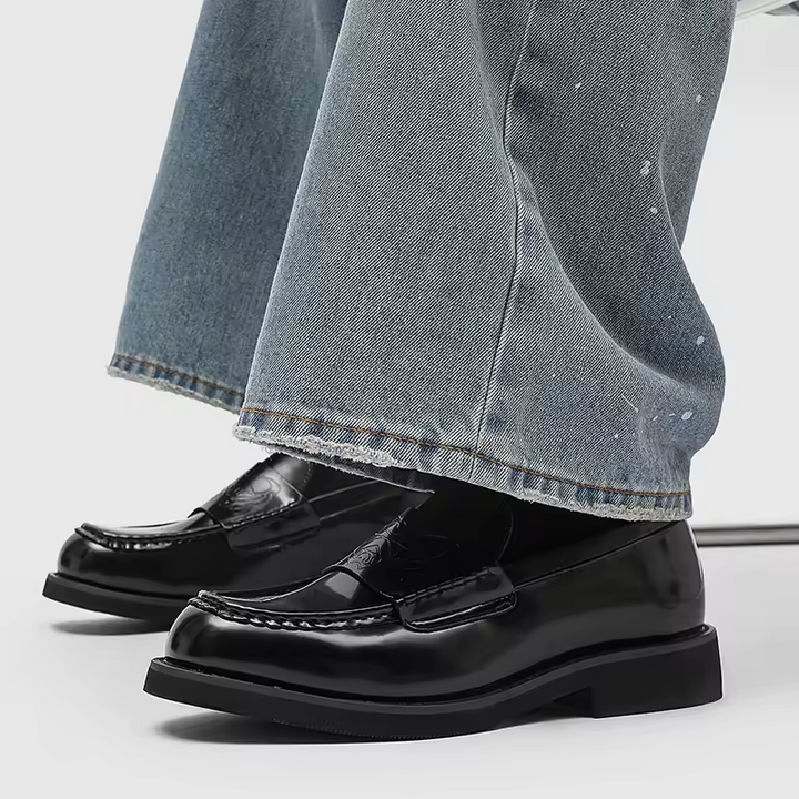 Classic men's polished black leather loafers. Stylish formal footwear for refined business looks.