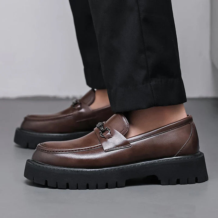 Polished black men's loafers, versatile for business casual or formal wear, exuding sharp style.