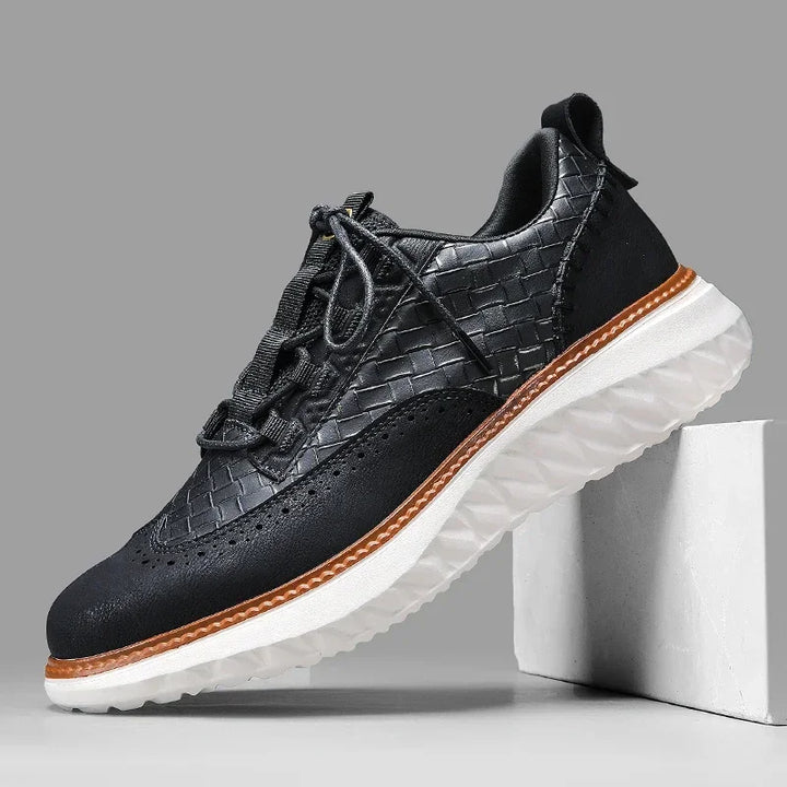 Close-up of men's black leather athletic sneakers, featuring a comfortable and breathable design.