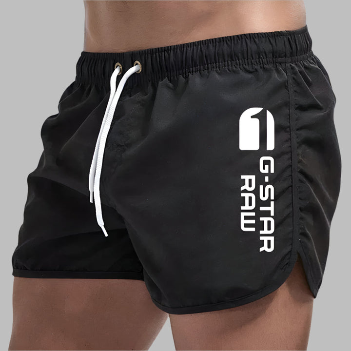 Stylish men's quick-dry swim trunks, perfect beachwear for pool & ocean activities. Comfortable athletic shorts.