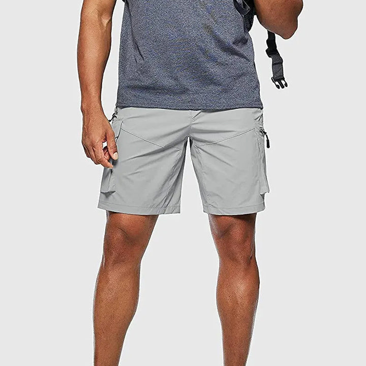 Beige men's cargo shorts with elastic waistband, designed for comfort during outdoor activities.