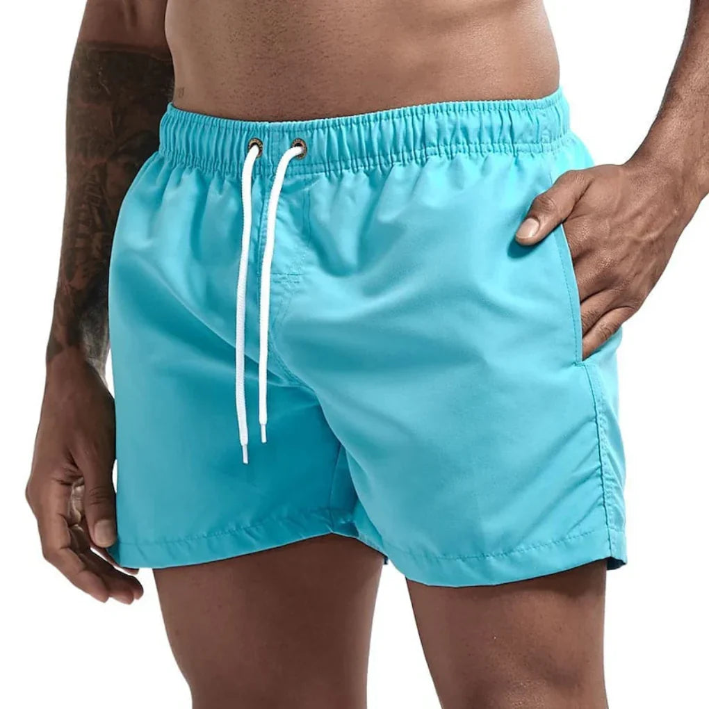 Men's quick-dry swim shorts in blue for beach & pool, perfect for summer vacation.