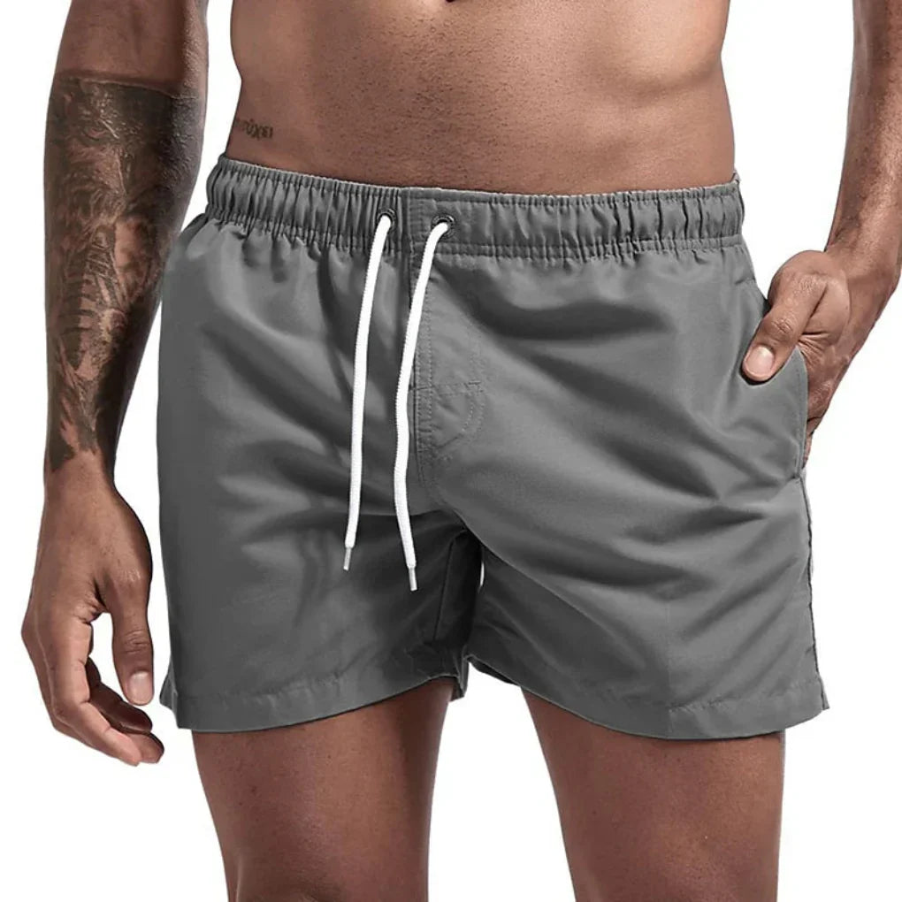 Vibrant patterned men's quick-dry swim shorts, perfect activewear for beach vacations.