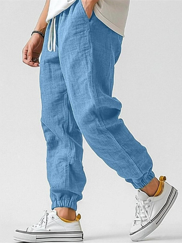Close-up: Men's cuffed joggers, highlighting drawstring waist & relaxed fit for maximum comfort.
