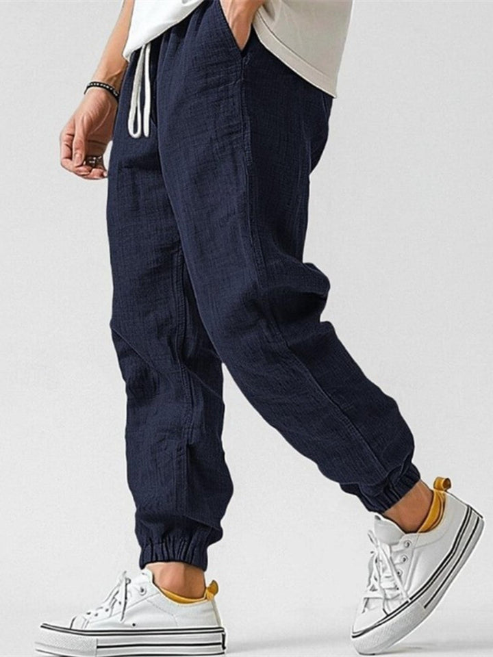 Versatile men's casual joggers, relaxed fit & cuffed design, ideal for travel, summer, or streetwear.
