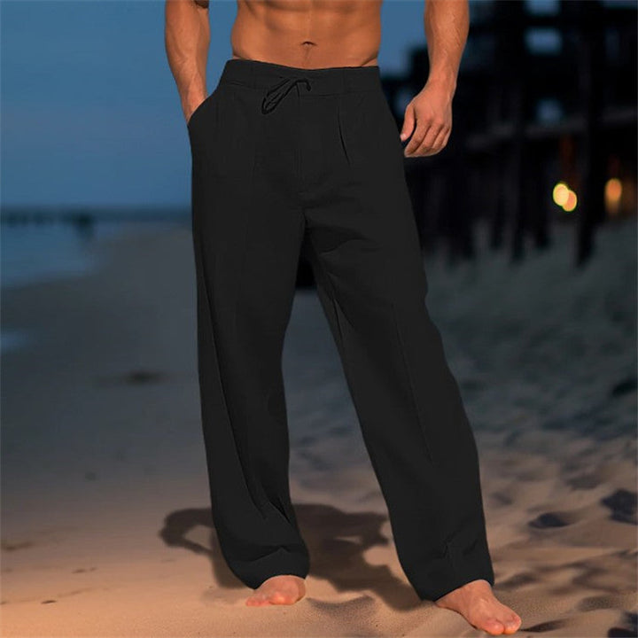 Black men's drawstring relaxed fit pants, versatile for spring fashion, travel, or lounge wear.