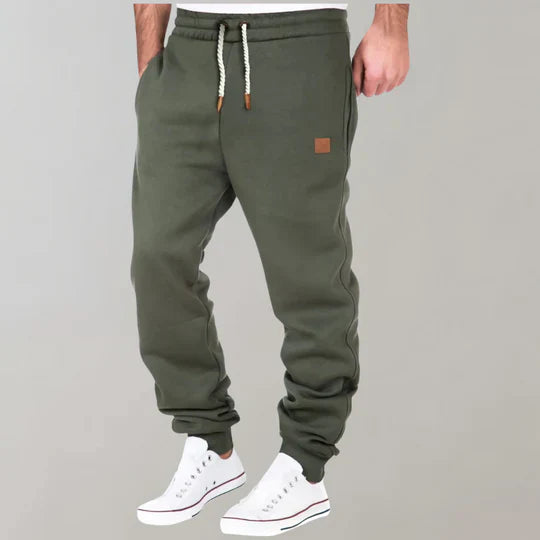Men's relaxed fit jogging pants in soft grey fabric for ultimate everyday comfort and casual style.
