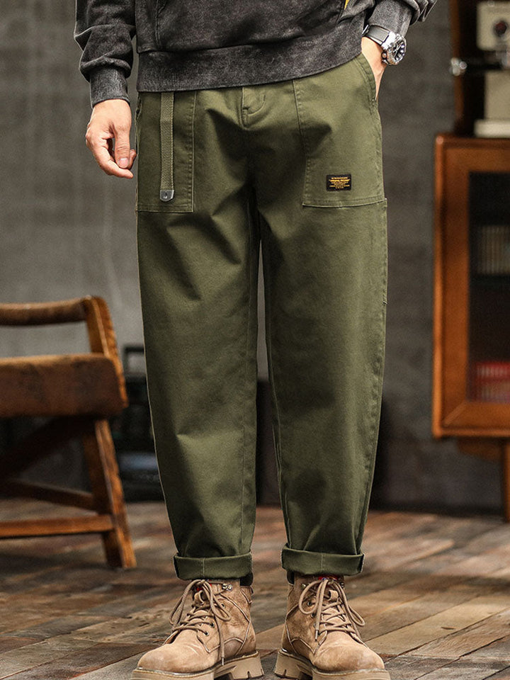 Side view of men's modern utility pants with a relaxed fit, highlighting the functional pocket details.