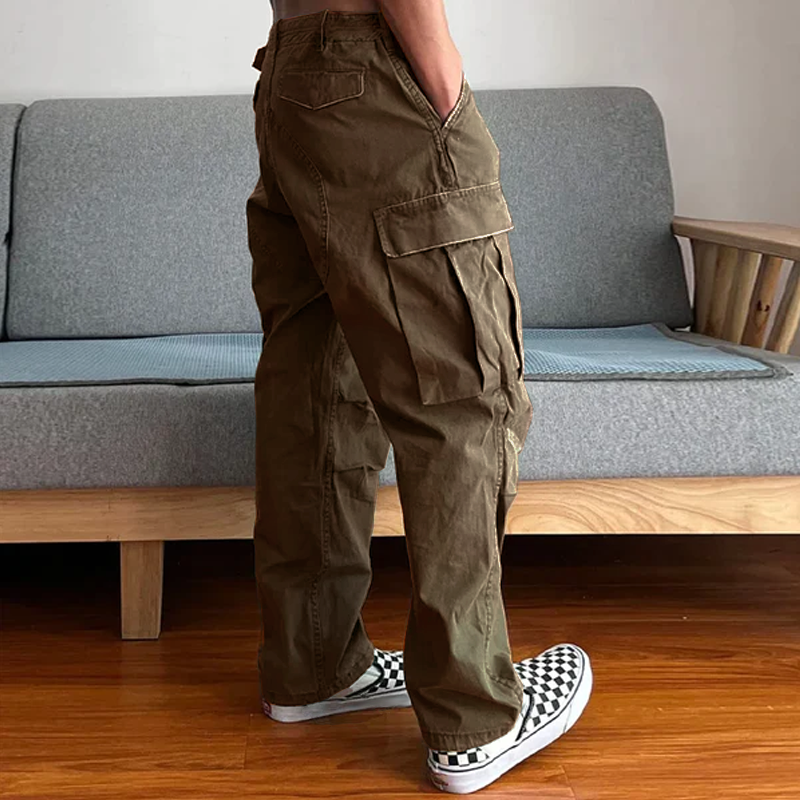 Model actively wearing men's relaxed fit washed chino cargo pants, great for dynamic casual everyday wear.