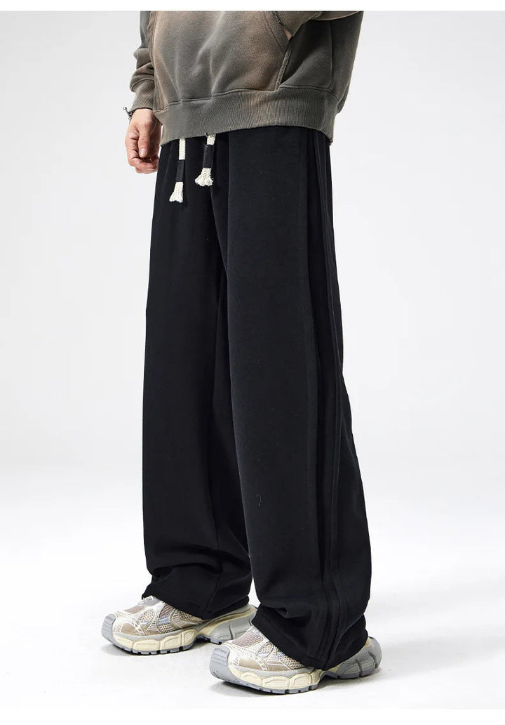 Comfortable men's loose fit wide leg casual drawstring trousers for daily wear.