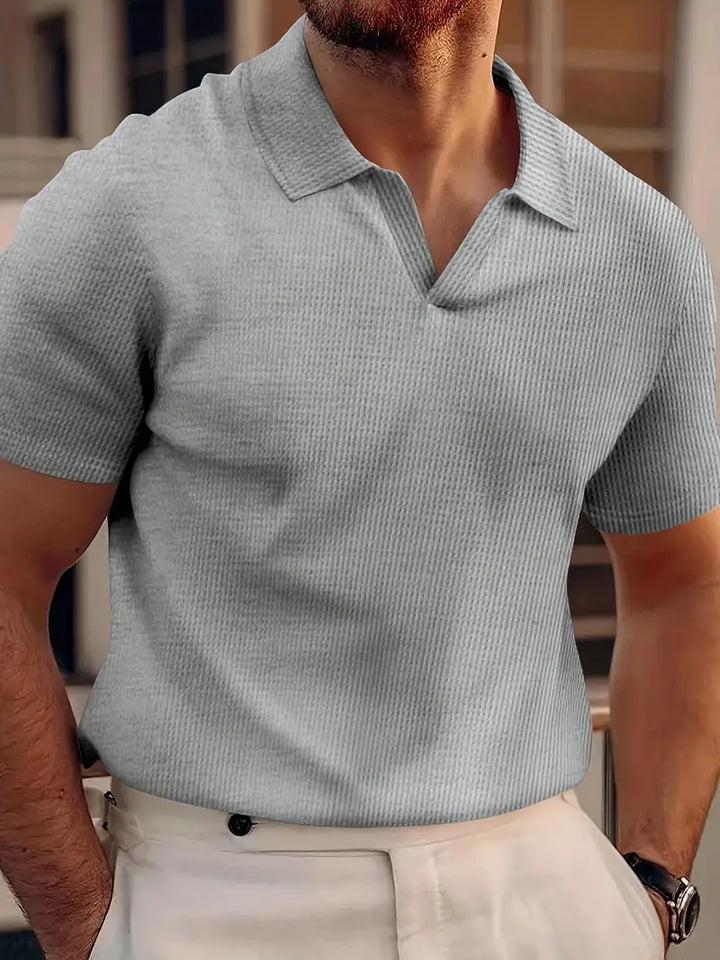 Textured ribbed men's polo shirt, slim fit short sleeve design, perfect for modern summer fashion.