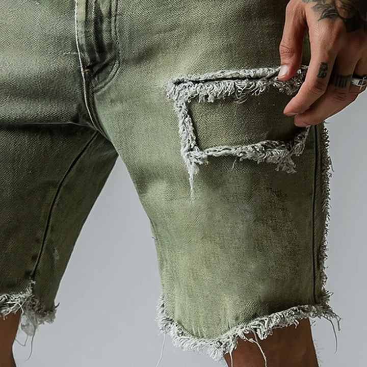 Stretch denim men's shorts with a ripped, distressed look. Comfortable straight leg fit, five-pocket design for summer wear.