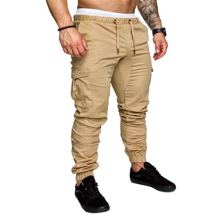 Close-up of practical multi-pockets on men's rugged cargo joggers, showcasing durable fabric for activewear.