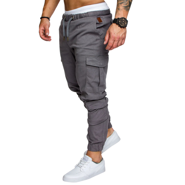 Close-up of rugged, durable fabric texture on men's multi-pocket cargo joggers, built for urban adventures.