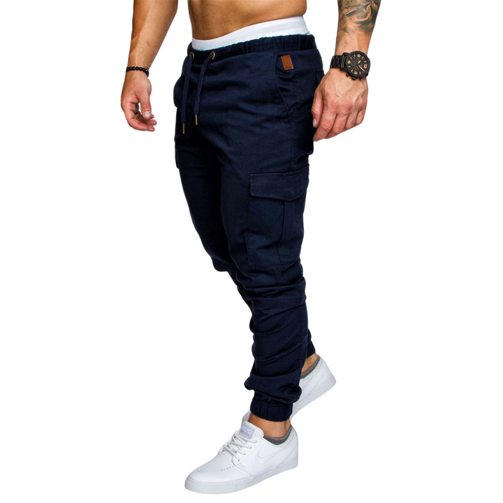 Folded stack of comfortable men's multi-pocket cargo joggers, perfect for casual or active urban wear.