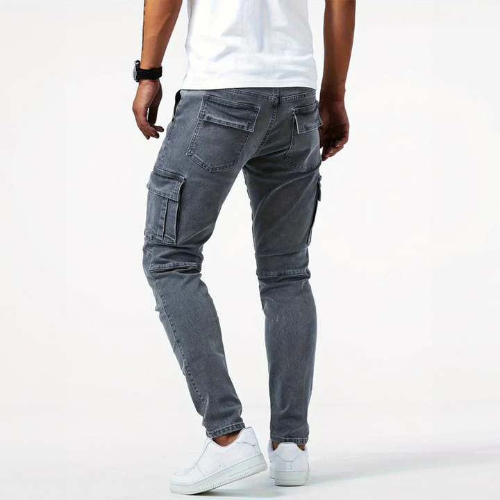 Detail of the side flap pocket on men's gray slim fit cargo pants, showing modern design.
