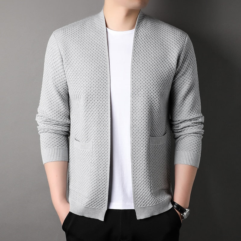 Casual menswear: a versatile slim fit knitted cardigan with button-front and two functional pockets.