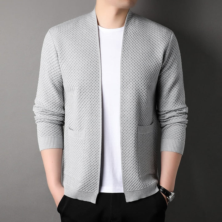 Casual menswear: a versatile slim fit knitted cardigan with button-front and two functional pockets.