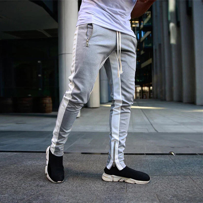 Men's slim fit track sweatpants with practical zip hems, ideal for athletic wear or casual street style.