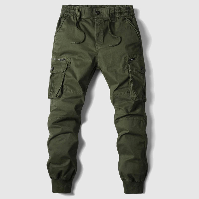 Close-up of men's slim fit cargo jogger pants, highlighting multi-pockets & adjustable waist for a modern utility look.